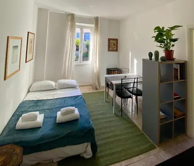 a bedroom with a bed and a dining room at Appartamento S. Pietro in Rome