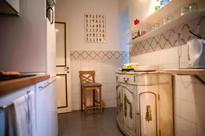 a kitchen with a stove and a sink in it at Farnese Apartment Navona Historic Center in Rome