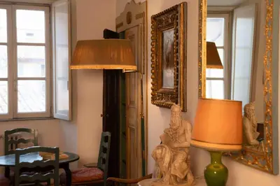 a living room with a lamp and a mirror at Farnese Apartment Navona Historic Center in Rome