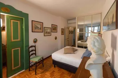 a bedroom with a bed and a chair in a room at Farnese Apartment Navona Historic Center in Rome
