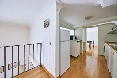a kitchen with a staircase leading to a living room at iFlat Retro Chic Apartment in Prati in Rome
