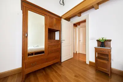 a room with a wooden cabinet and a mirror at iFlat Retro Chic Apartment in Prati in Rome