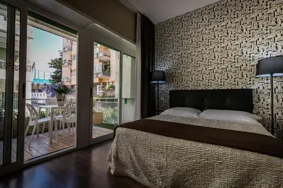 a bedroom with a large bed and a balcony at B&B Residenza Gregorio VII in Rome