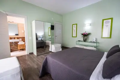 a bedroom with a bed and a living room at B&B Residenza Gregorio VII in Rome