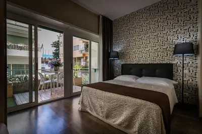a bedroom with a large bed and a balcony at B&B Residenza Gregorio VII in Rome