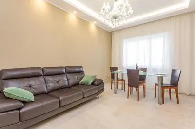 a living room with a couch and a table at 2-Bedroom Retreat near Metro & Parks in Rome