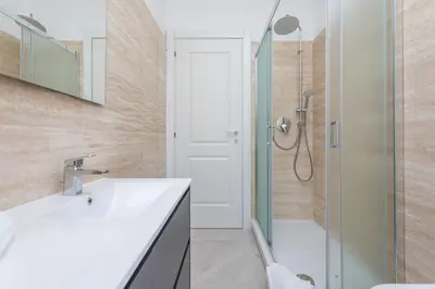 a bathroom with a sink and a shower at 2-Bedroom Retreat near Metro & Parks in Rome