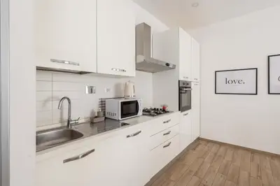 a white kitchen with a sink and a microwave at LoveRhome Apartment 1 in Rome