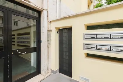 a black door on a building with windows at LoveRhome Apartment 1 in Rome