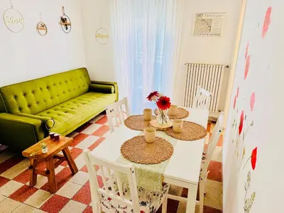 a living room with a table and a green couch at Holiday Homes Rome - Monte Verde 61 - near Trastevere in Rome