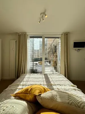 a bedroom with a bed and a large window at Matilda House EUR 4 posti letto in Rome