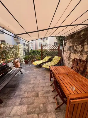 a patio with benches and a table and chairs at Matilda House EUR 4 posti letto in Rome