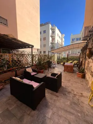 a patio with couches and tables in a building at Matilda House EUR 4 posti letto in Rome