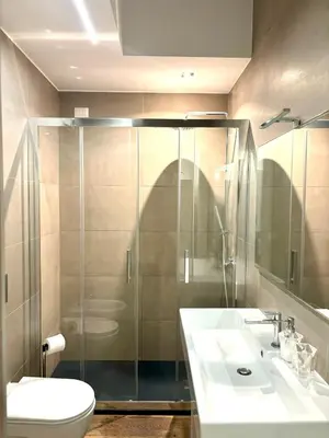 a bathroom with a shower and a toilet and a sink at Matilda House EUR 4 posti letto in Rome