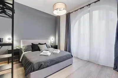 a bedroom with a bed and a large window at Classy 2-bdr in Termini district in Rome