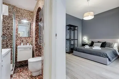 a bedroom with a bed and a bathroom at Classy 2-bdr in Termini district in Rome