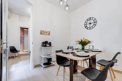 a dining room with a table and chairs at Classy 2-bdr in Termini district in Rome