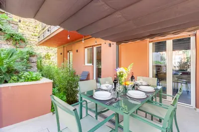 a green table and chairs on a patio at Mom's home - A few stops from the city centre in Rome