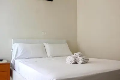 two stuffed animals sitting on top of a bed at Hotel Domus Rome in Rome
