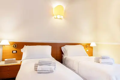 two beds sitting next to each other in a room at Hotel Domus Rome in Rome