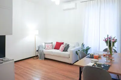 a living room with a white couch and a table at Suite 52 Trastevere in Rome