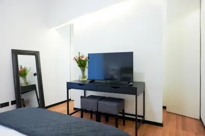 a bedroom with a desk with a mirror and a bed at Suite 52 Trastevere in Rome