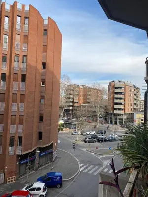 a parking lot with cars parked in front of a building at Suite 52 Trastevere in Rome