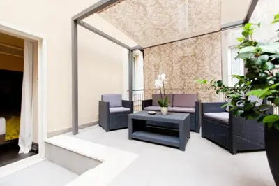 a living room with couches and a coffee table at Quirinale Luxury Rooms in Rome