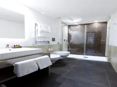 a bathroom with a sink and a toilet and a shower at Quirinale Luxury Rooms in Rome