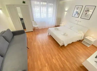 a living room with a bed and a couch at Golden Essence Apartment - terrace & metro in Rome