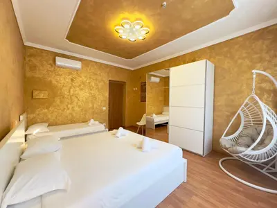 a bedroom with a white bed and a swing at Golden Essence Apartment - terrace & metro in Rome