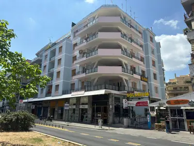 a tall white building on the side of a street at Golden Essence Apartment - terrace & metro in Rome