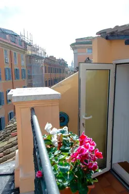a balcony with a pile of flowers on a building at Saint Louis Penthouse, cozy little apartment next to Pantheon in Rome