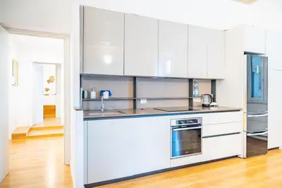 a kitchen with white cabinets and stainless steel appliances at Lion 99 in Rome