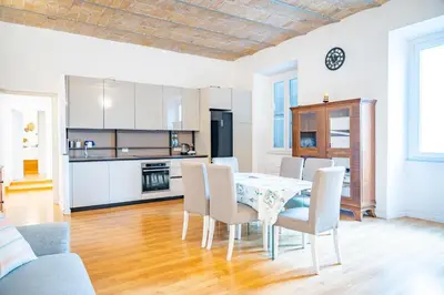 a kitchen and dining room with a table and chairs at Lion 99 in Rome