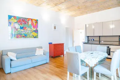 a living room with a blue couch and a table at Lion 99 in Rome