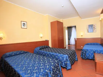 a hotel room with two beds with blue sheets at Casa Di Santa Francesca Romana a Ponte Rotto in Rome
