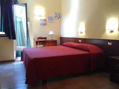 a hotel room with a bed with a red blanket at Casa Di Santa Francesca Romana a Ponte Rotto in Rome