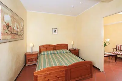 a bedroom with a bed and a living room at Casa Di Santa Francesca Romana a Ponte Rotto in Rome