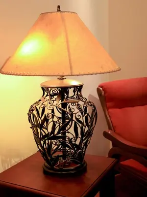a lamp sitting on a table next to a chair at Casa Di Santa Francesca Romana a Ponte Rotto in Rome