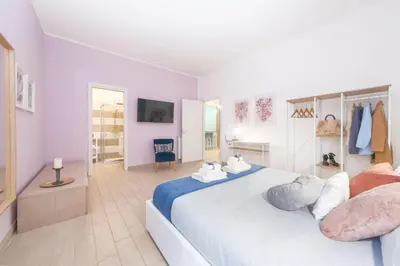 a bathroom with a sink and a bed in a room at Luxury Vatican Home - Private Garden in Rome