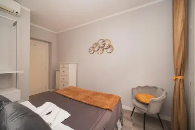 a bedroom with a bed and a chair at Venus Penthouse - Favoloso attico in pieno centro a Roma in Rome