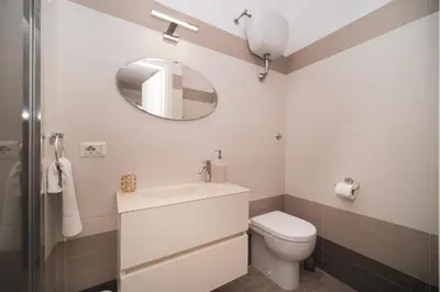 a bathroom with a white toilet and a mirror at Venus Penthouse - Favoloso attico in pieno centro a Roma in Rome