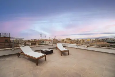 two chairs and a coffee table on a roof at Venus Penthouse - Favoloso attico in pieno centro a Roma in Rome