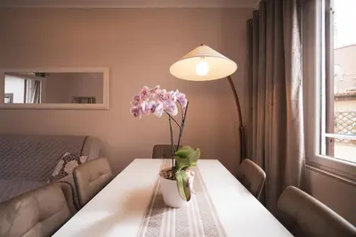 a table with a vase of flowers on it at Venus Penthouse - Favoloso attico in pieno centro a Roma in Rome