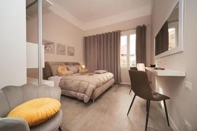 a bedroom with a bed and a couch and a table at Venus Penthouse - Favoloso attico in pieno centro a Roma in Rome
