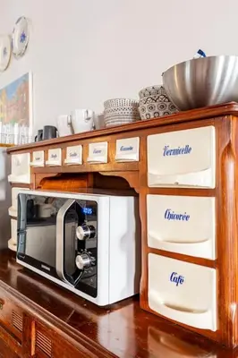 a microwave in a wooden cabinet with drawers at Delizioso appartamento a Trastevere in Rome