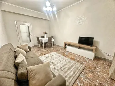 a living room with a couch and a tv at Maison Grimaldi Roma in Rome