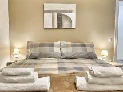 a bedroom with a bed with a plaid blanket at Maison Grimaldi Roma in Rome