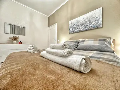 a bedroom with a bed with towels on it at Maison Grimaldi Roma in Rome